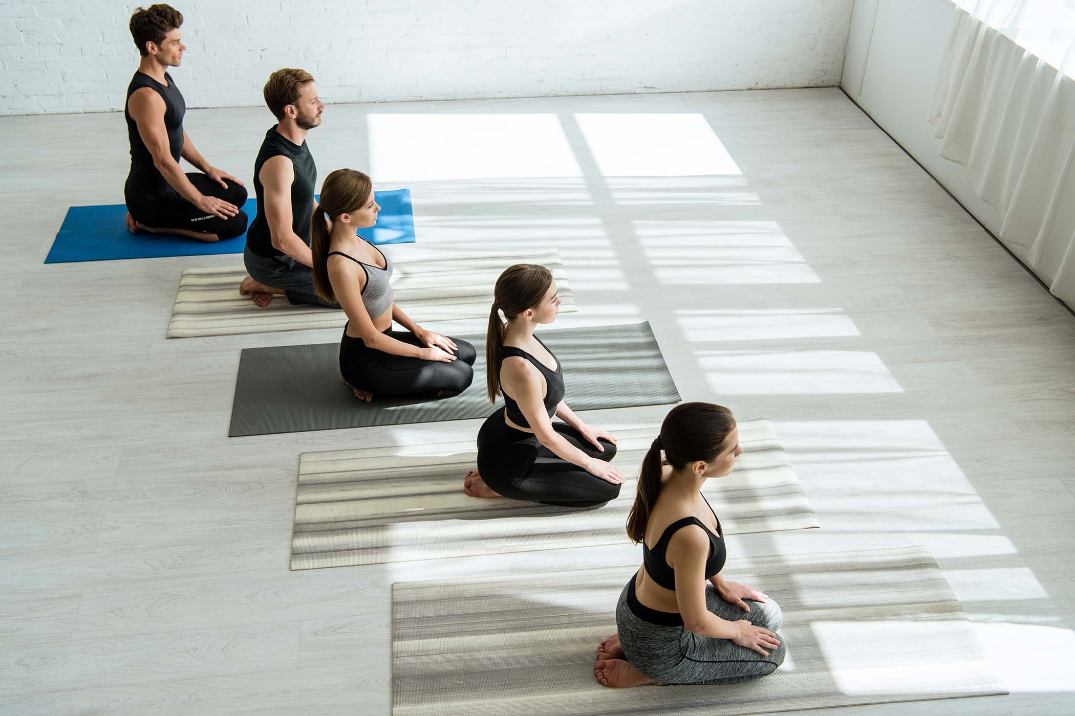 high-angle-view-of-five-young-people-meditating-in-57E48PC-1.jpg